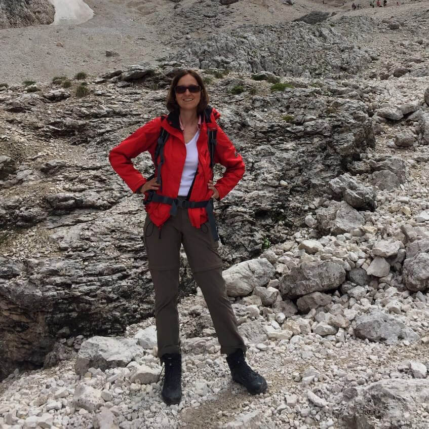Keen employee standing at the bottom of a mountain
