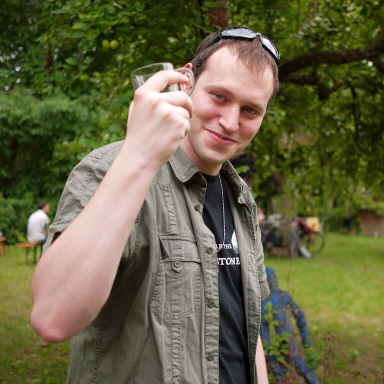 Keen employee smiling and holding up a glass